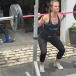 CrossFitter back squats using the best crossfit belt.